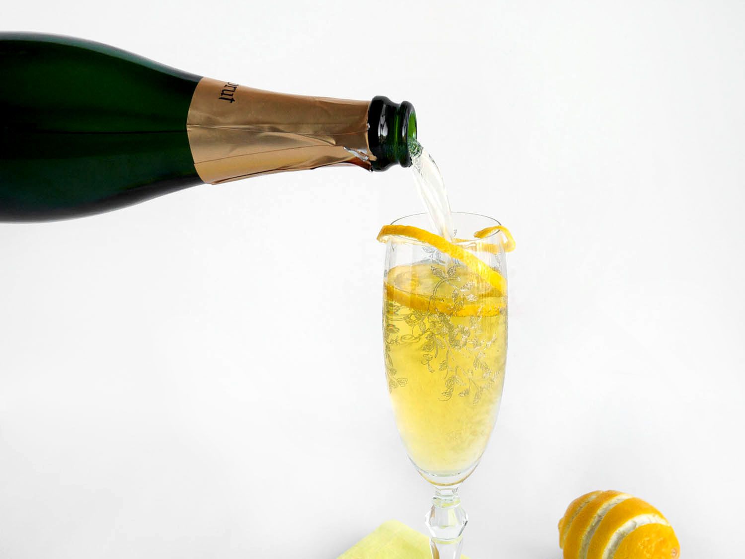 Cava is poured into a flute to make a sparkling Suze cocktail.