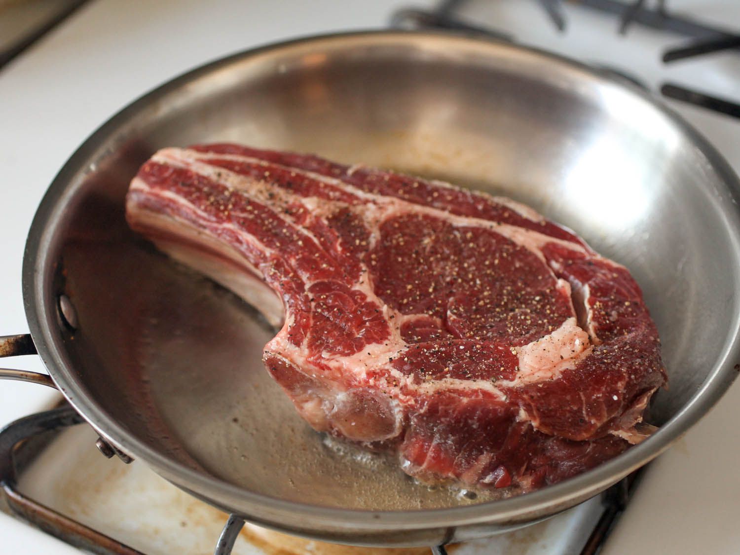 Steak searing in skillet.