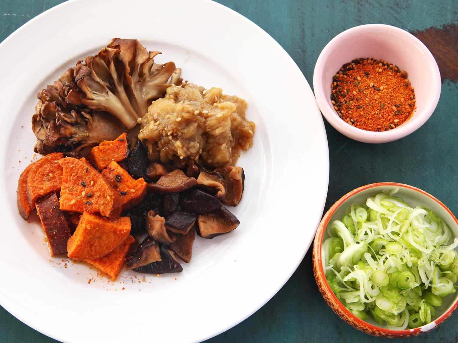 Toppings for vegan ramen: roasted sweet potatoes, mushrooms, and eggplant; soaked dried mushrooms, sliced scallions, togarashi.