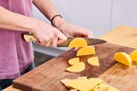 A person dices butternut squash using the Zwilling Kanren 8 Inch Chef's Knife