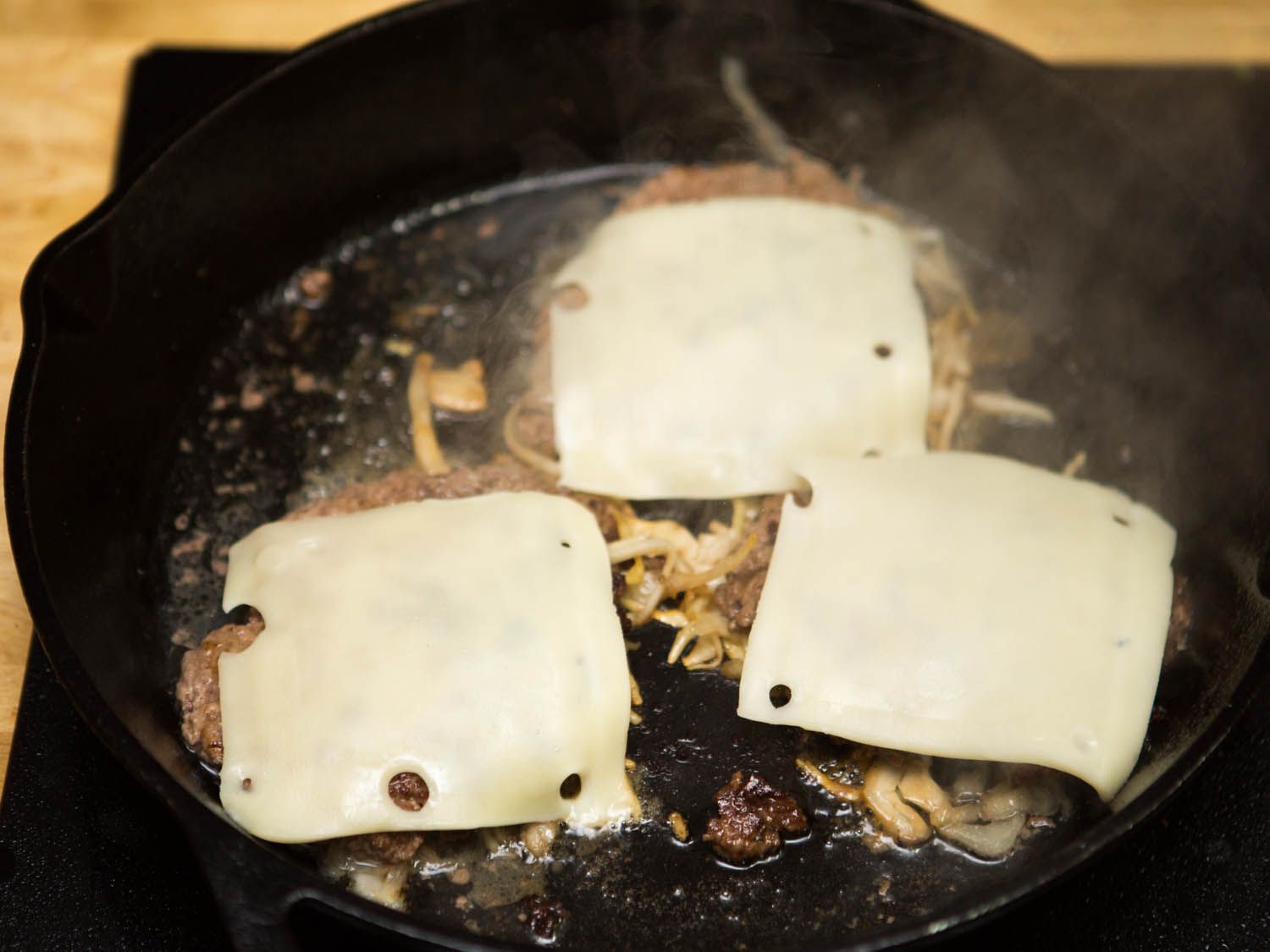 swiss cheese on top of burger patties