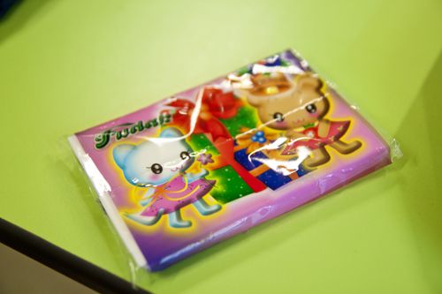 A tissue packet holding a seat at a table in a Singapore hawker center.