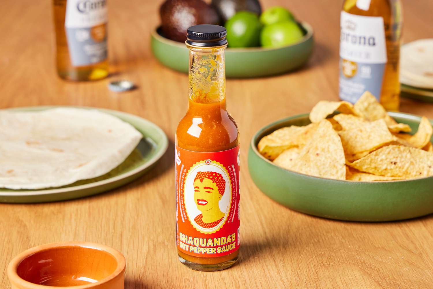 Shaquanda Will Feed You Hot Pepper Sauce on table