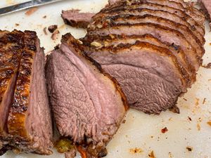 Sliced cooked beef roast presented on a cutting board