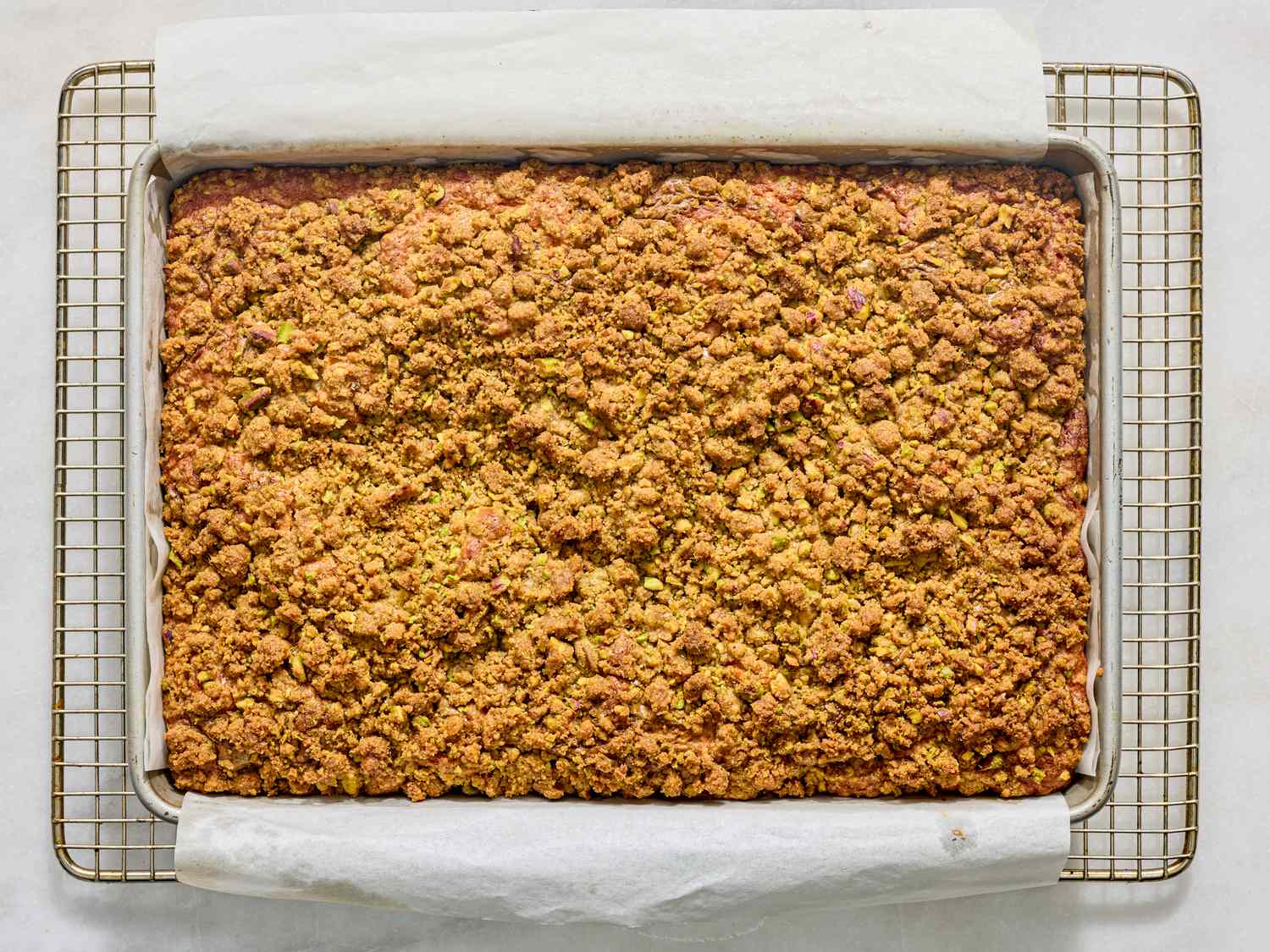 Tray of coffee cake with a crumbly topping on a cooling rack