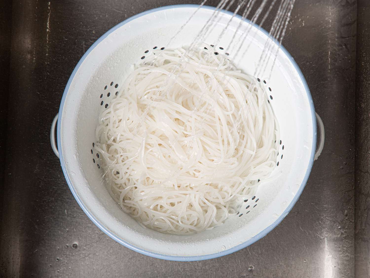 Overhead view of rinsing noodles
