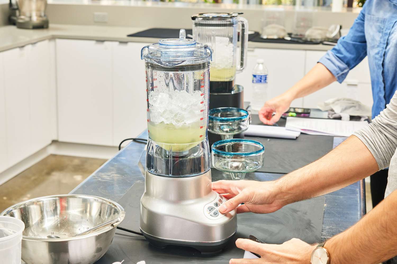 A person blends juice and ice using the Breville Fresh & Furious Blender