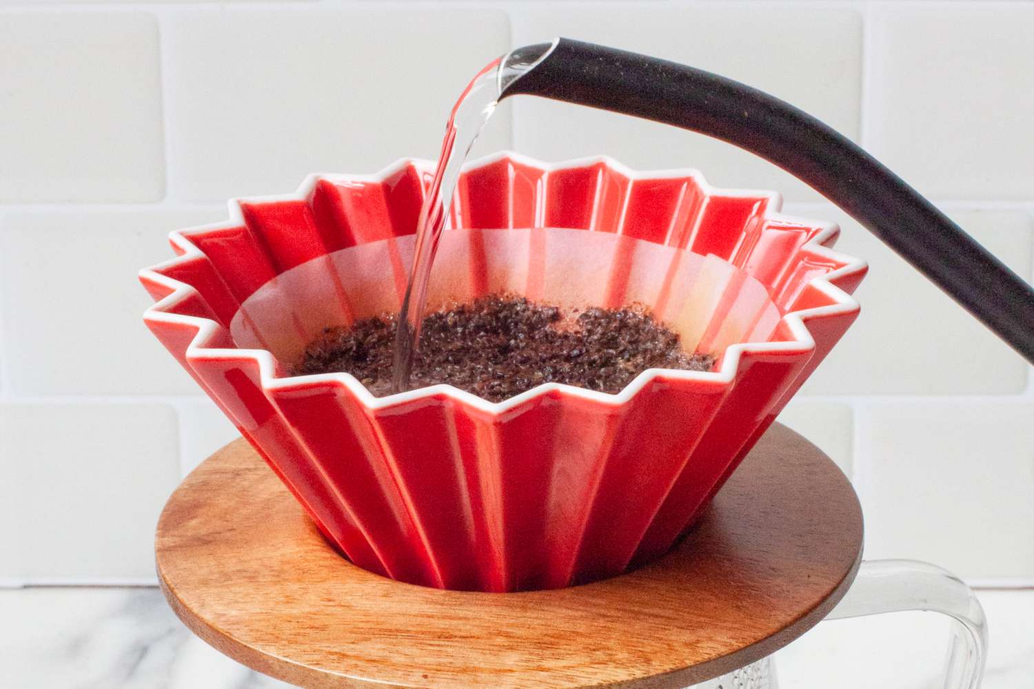 A kettle pouring water into the Origami dripper