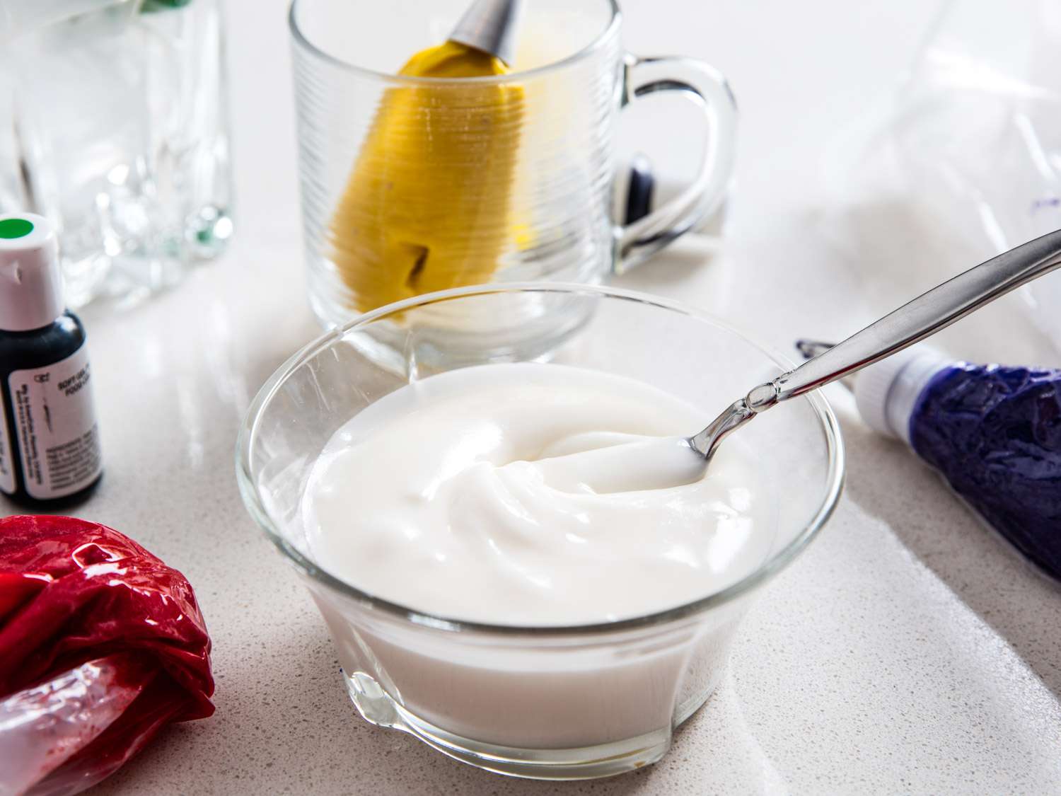 A glass bowl containing royal icing. 