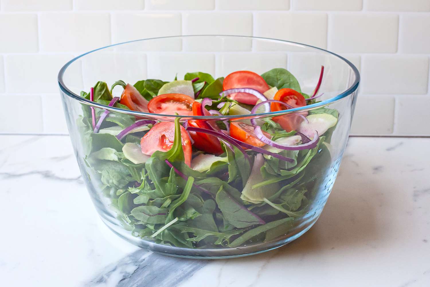 a salad served in the glass bowl of the oxo spinner