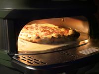a pizza cooking inside the gozney tread