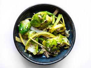 Overhead of bowl filled with pa-muchim salad made with Brussels sprouts and leeks.