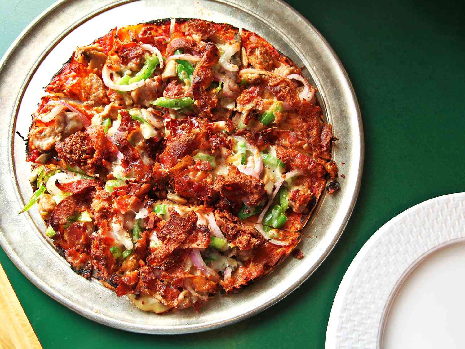 A pizza from Imo's on a metal pizza serving tray 