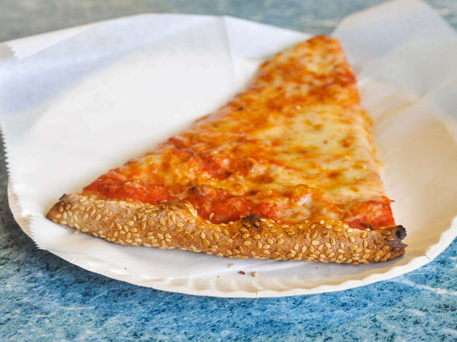 A cheese slice with sesame crust from Ciccio's