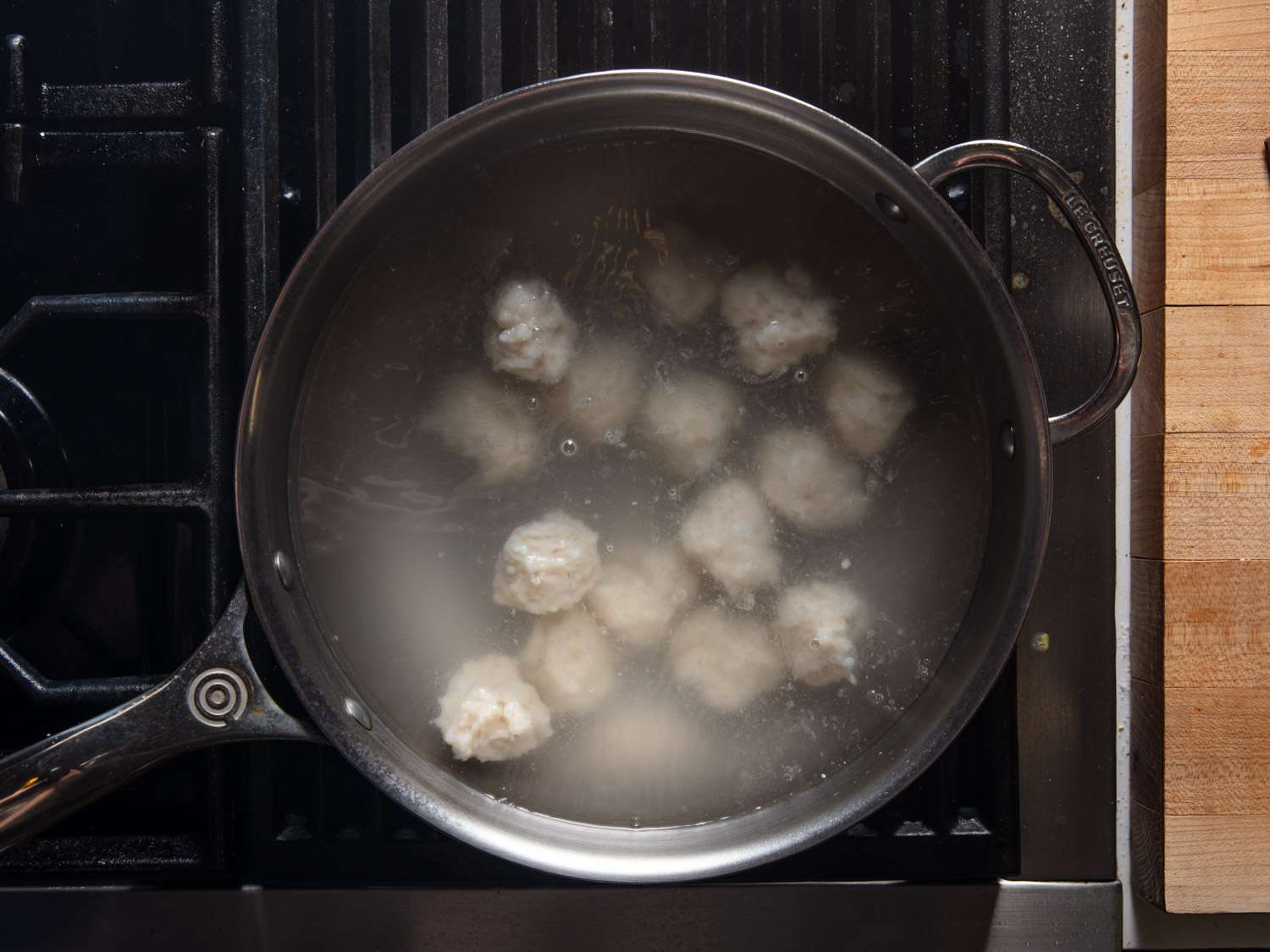 Squid balls boiling in a pot 