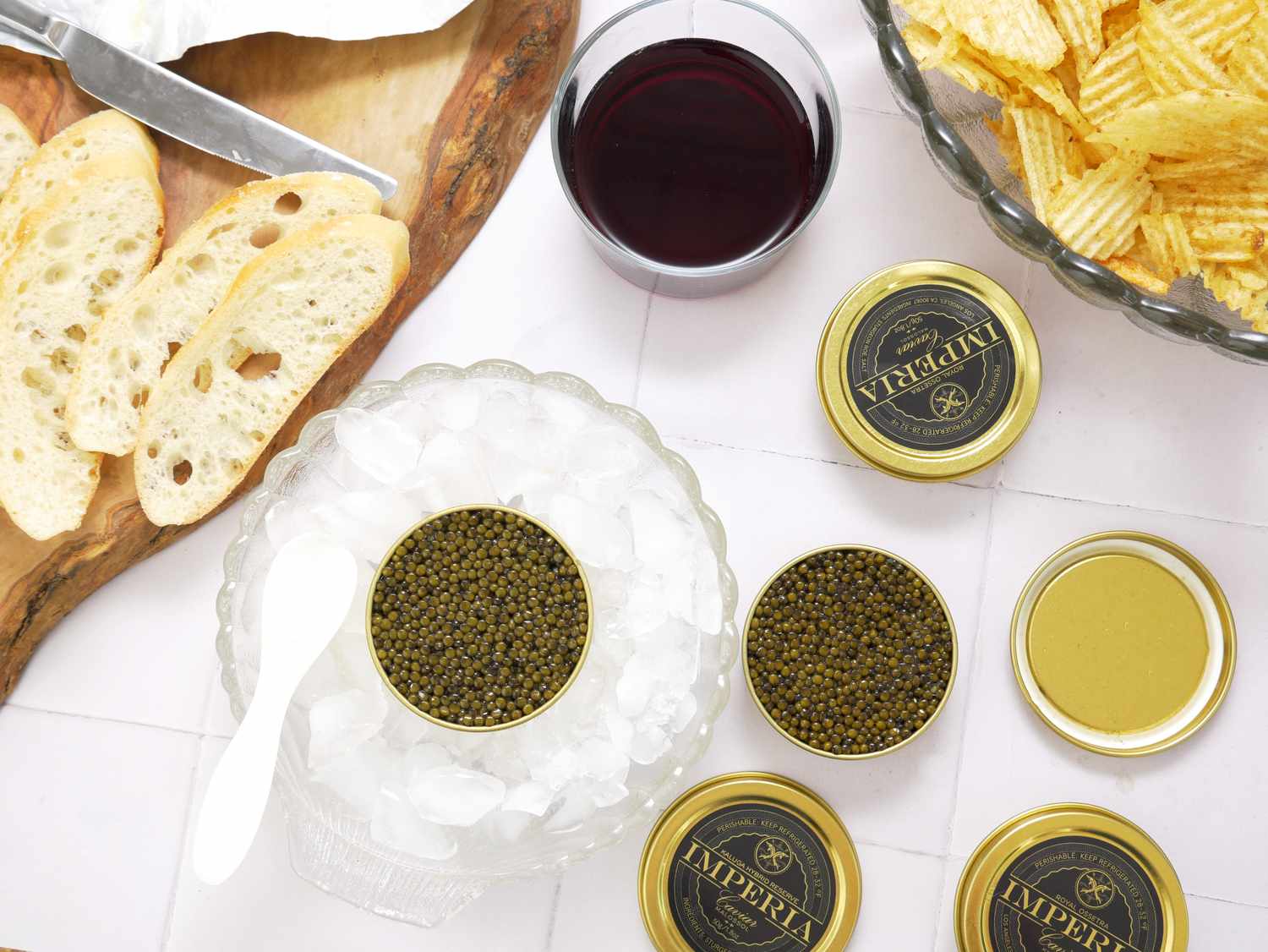 Caviar served with bread potato chips and a glass of red wine