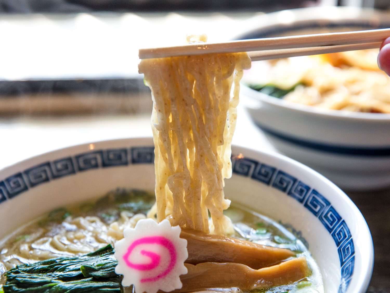 Noodles being pulled out of shio ramen at Ramen Shack