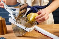 putting a cooked potato into the hopper