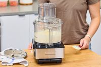 A person uses the Cuisinart 14-Cup Food Processor to puree food