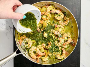 Overhead view of pouring chutney into pan