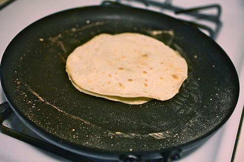 Pancakes being cooked on a griddle.