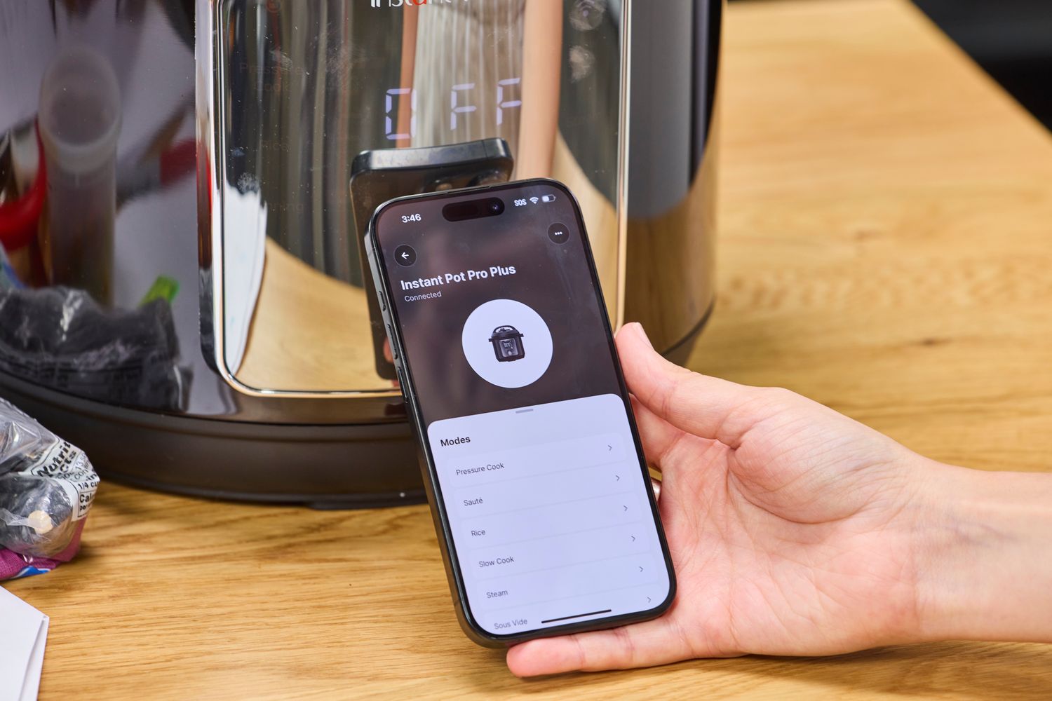 A smartphone is used to control the Instant Pot Pro Plus 6-quart Smart WiFi Multi-Cooker