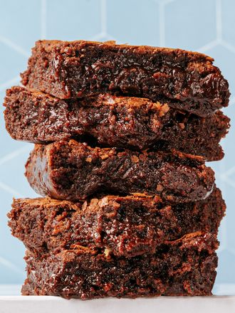 Stacked fudgy brownies with a geometric background