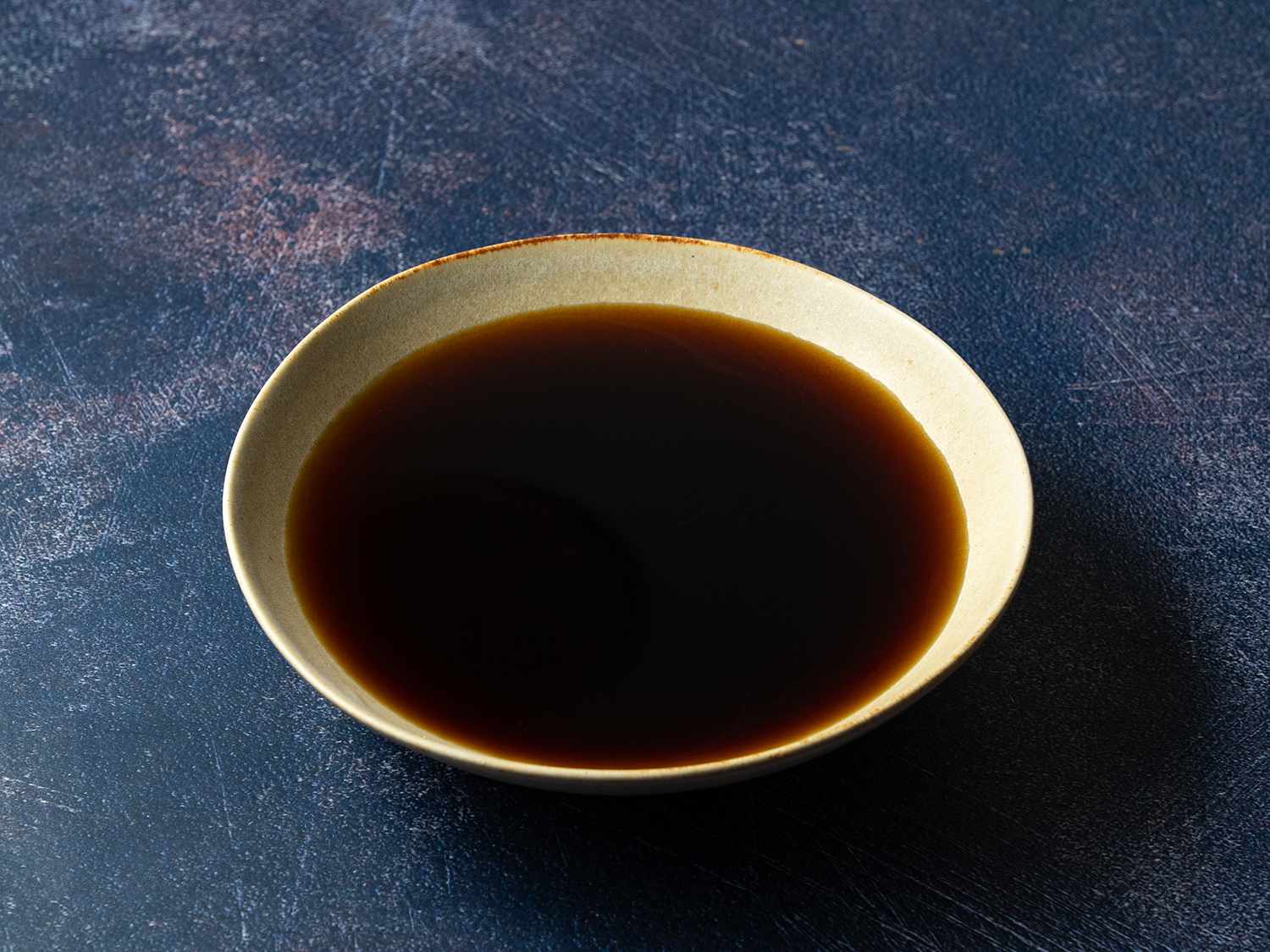 Soy sauce mixture containing water, sake, soy, mirin, and sugar in a bowl.