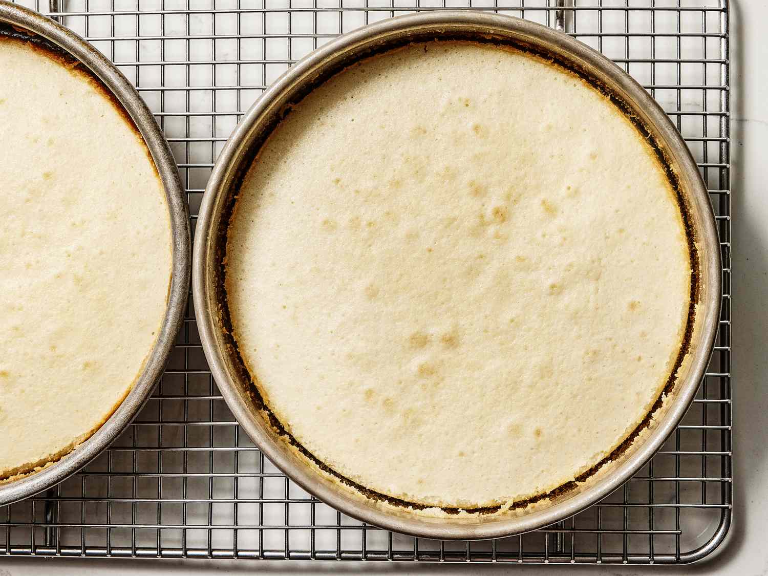 Cake pans on cooling racks after being cooled 