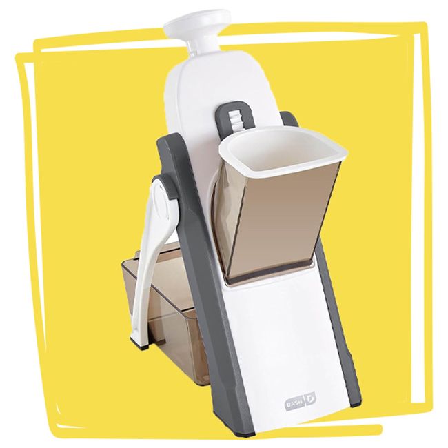 A mandoline slicer kitchen tool with a safety holder and design for slicing vegetables displayed against a yellow background