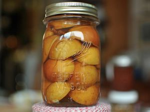 Large canning jar filled with pickled seckel pears