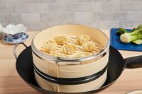 a bamboo steamer with dumplings inside