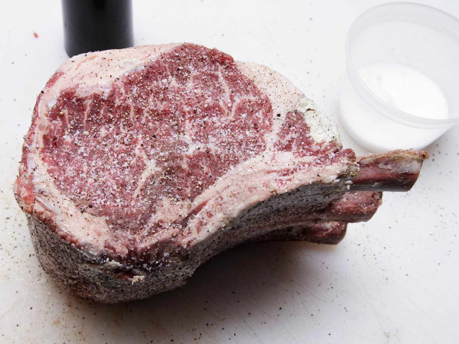 A raw prime rib with a lot of marbling.