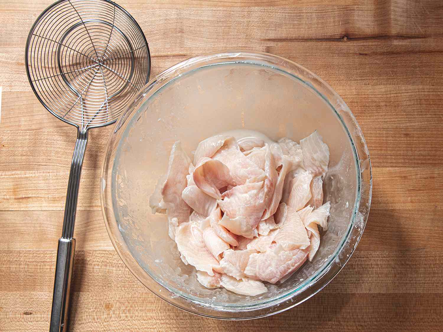 Fish marinating in cornstarch next to a spider.