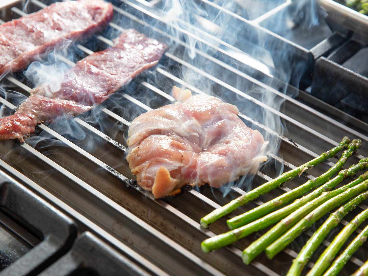 Chicken sears on the GrillGrate, showing its more extreme heat