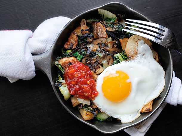 Overhead view of Spicy Potato, Bok Choy, and Shallot Hash, served in a cast iron skillet.