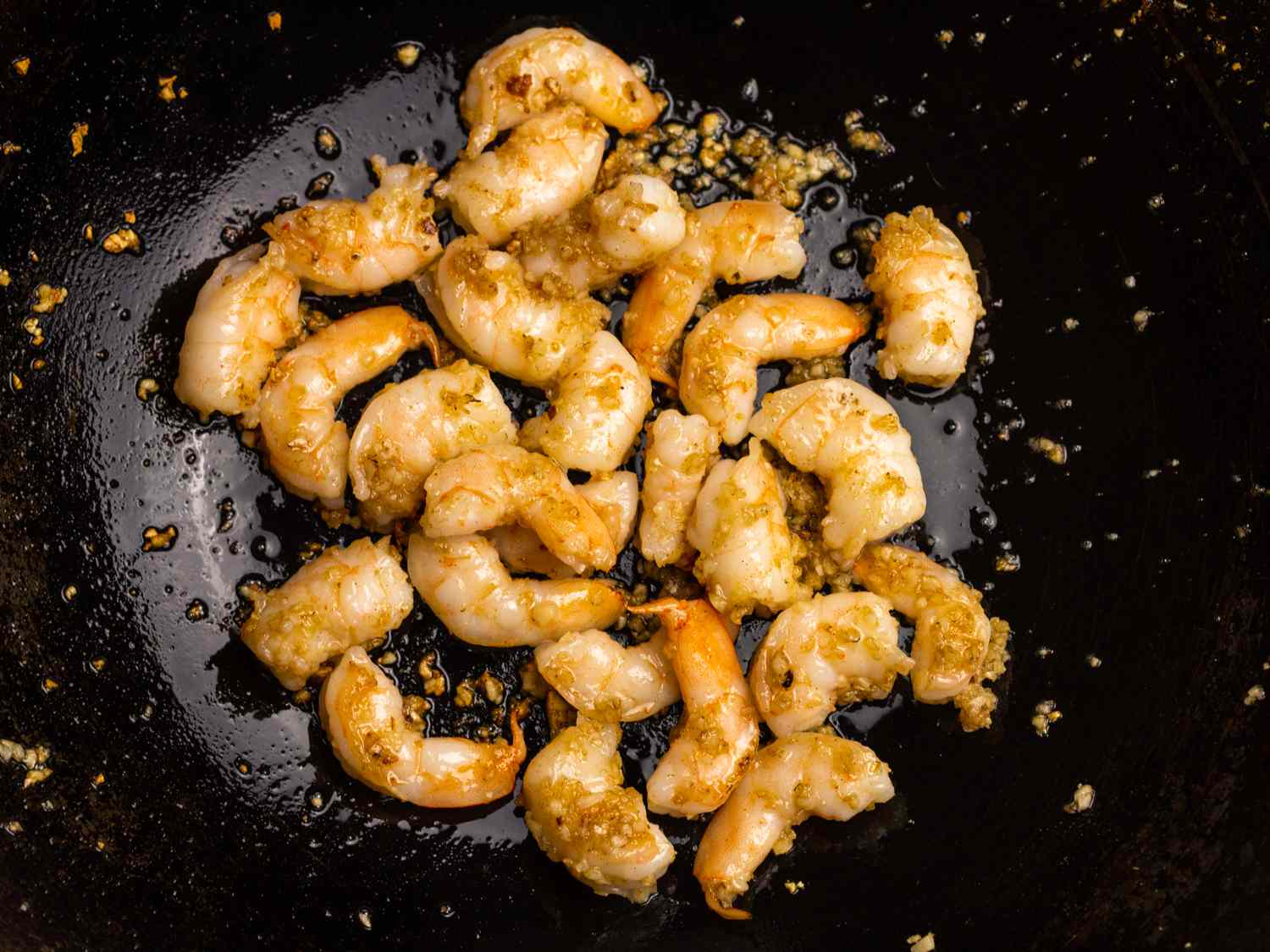 shrimp and garlic cooking in a wok
