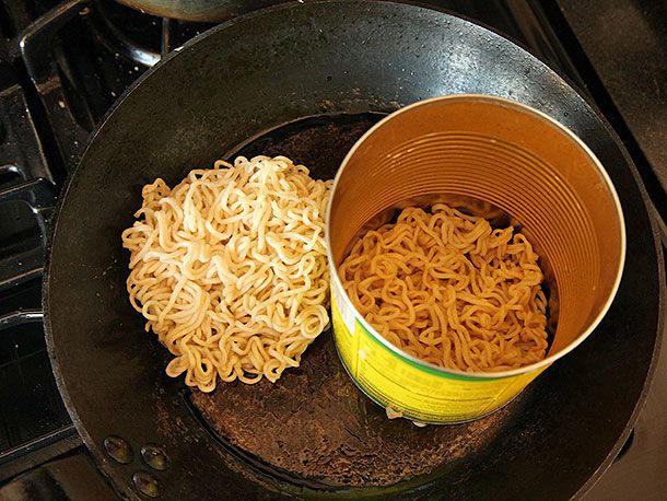 Cooked instant ramen noodles pressed into an open-ended can to form disks.