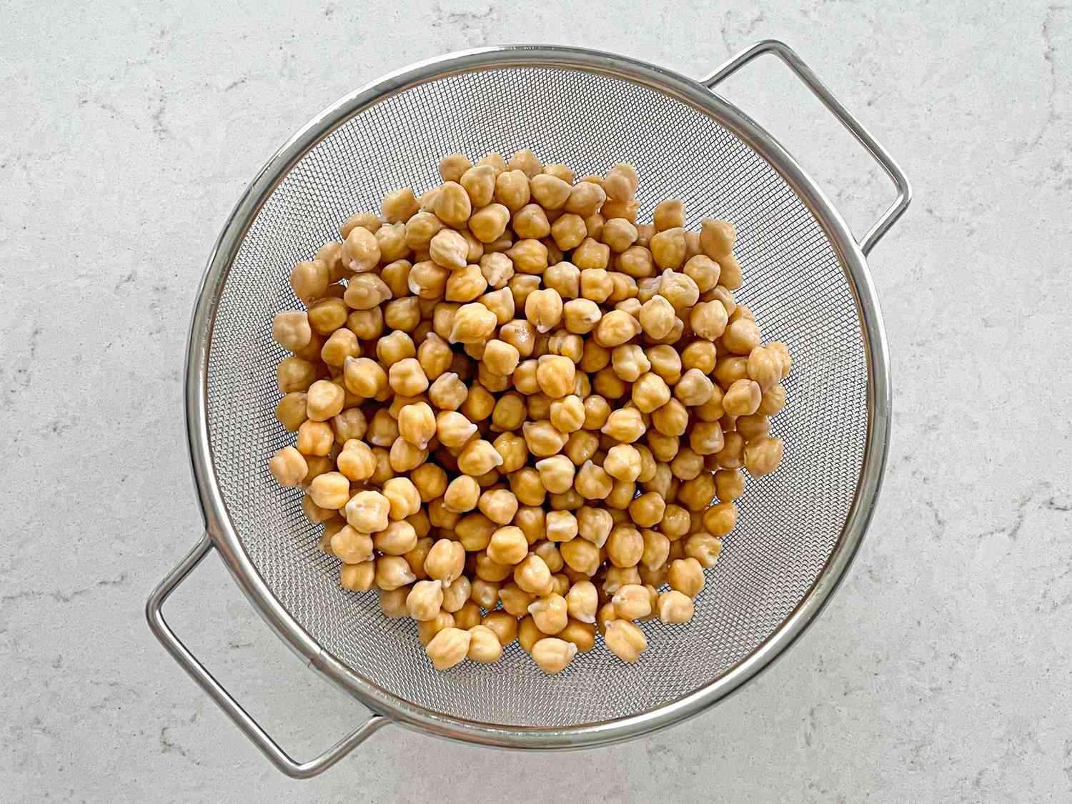 Overhead view of chickpeas in colander