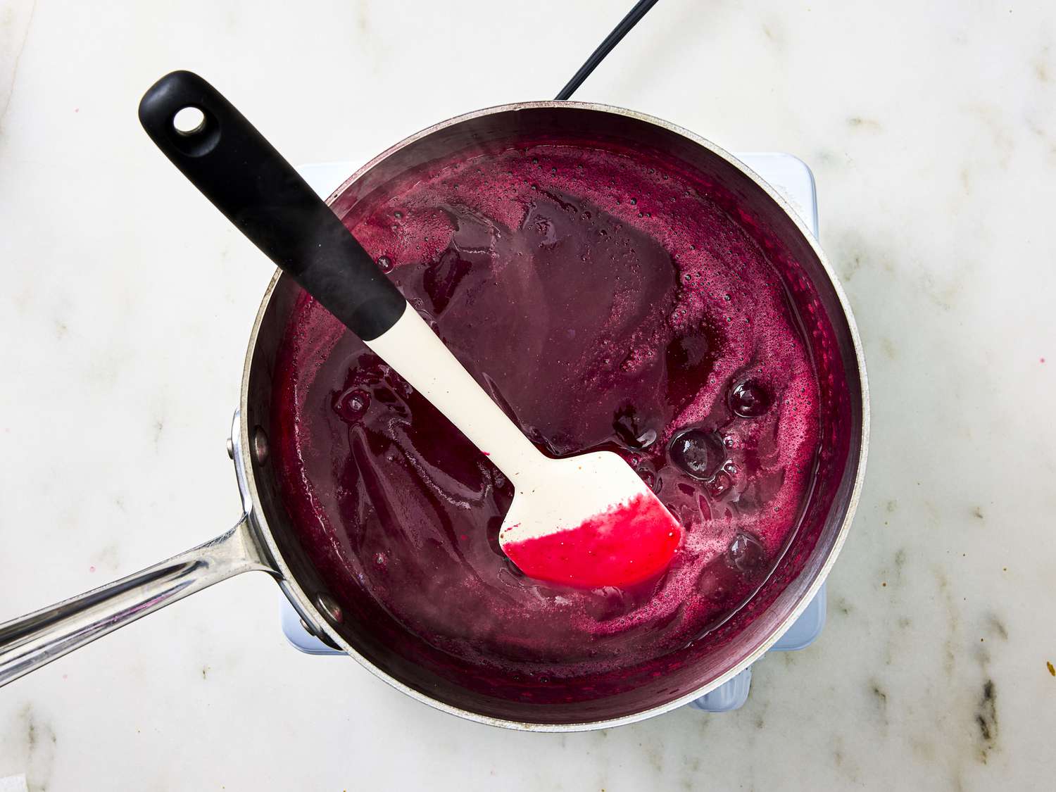 Beet and cherry soup mixture in a pan