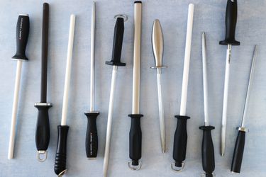 a bunch of honing rods on a pale blue background