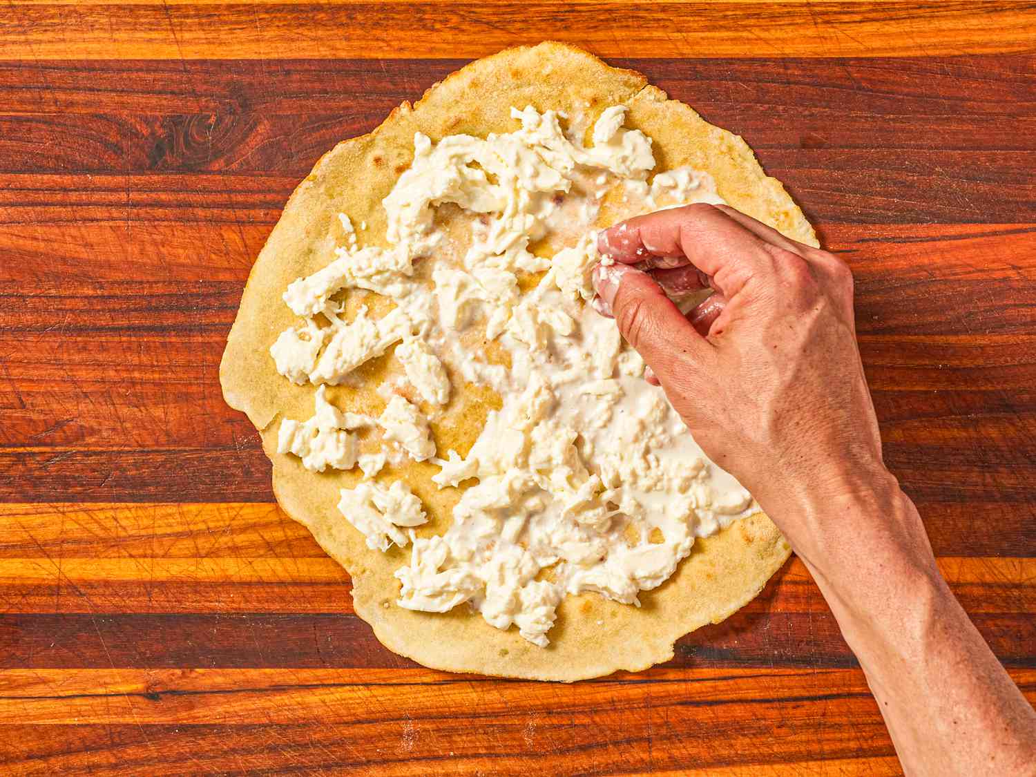 Overhead of adding cheese to dough
