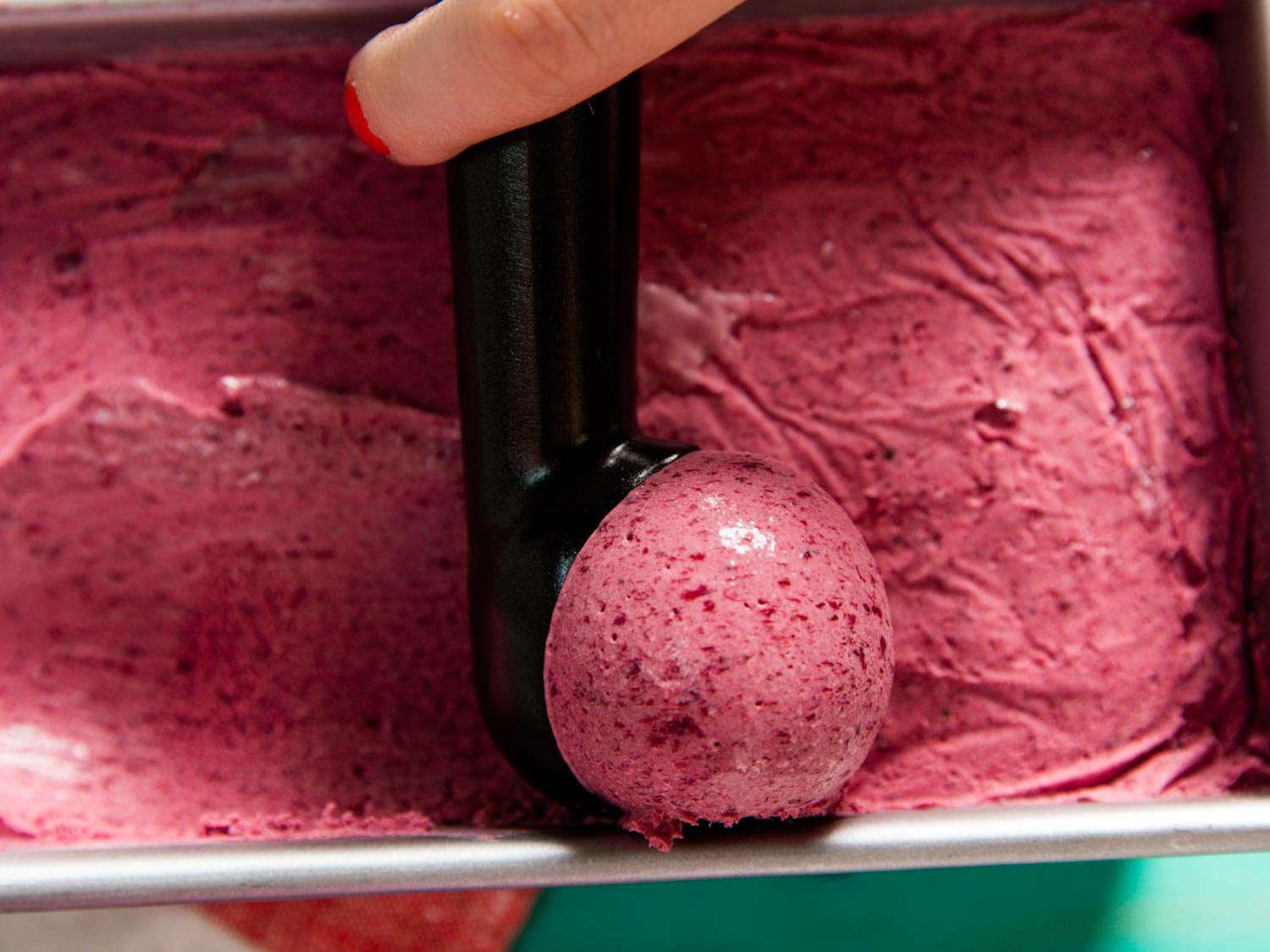 Scooping cherry ice cream.