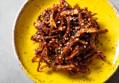 A plate of stir-fried anchovy banchan with sesame seeds.