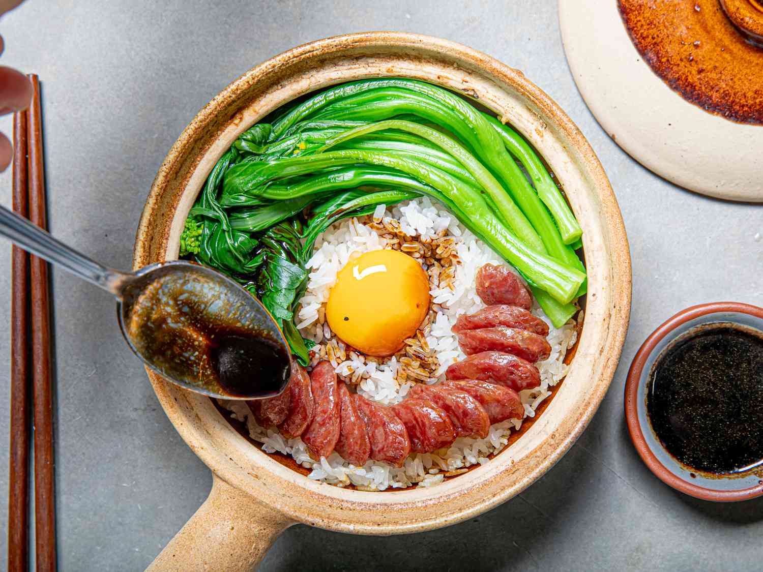 Cantonese clay pot rice with Chinese sausage and greens.