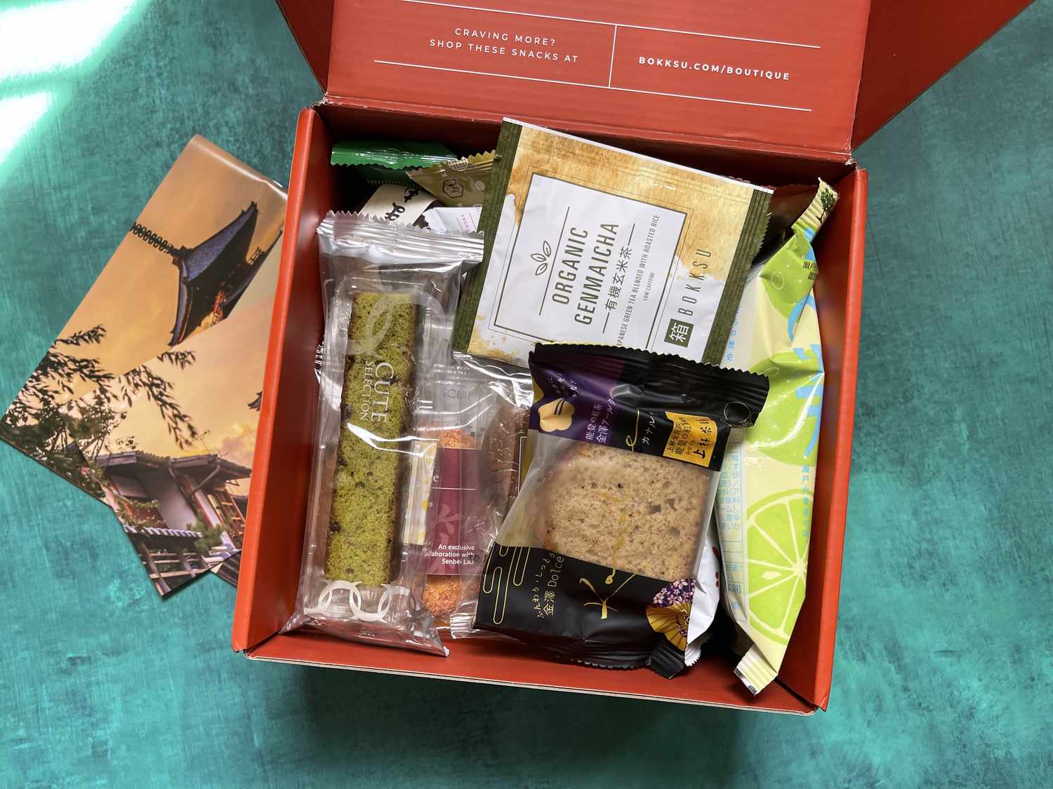 a box of different Japanese snacks on a blue surface