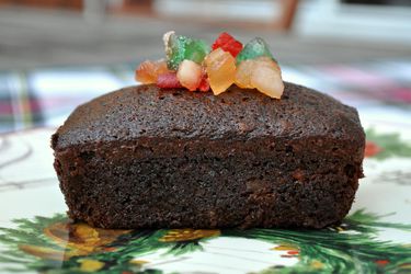 Profile view of an individual spiced fruitcake, topped with extra candied fruit mix.