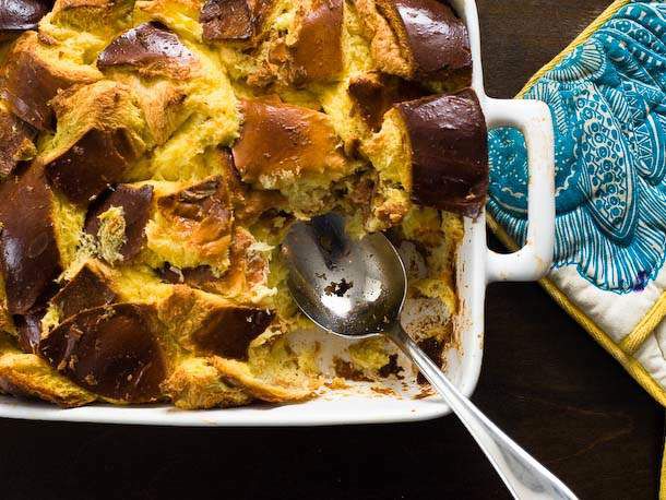Serving up warm bread pudding from a baking dish.