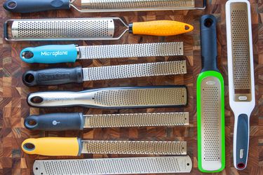a variety of rasp-style graters on a wooden countertop
