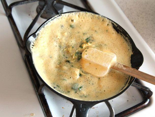 The egg-ramp mixture is added to a cast iron skillet.